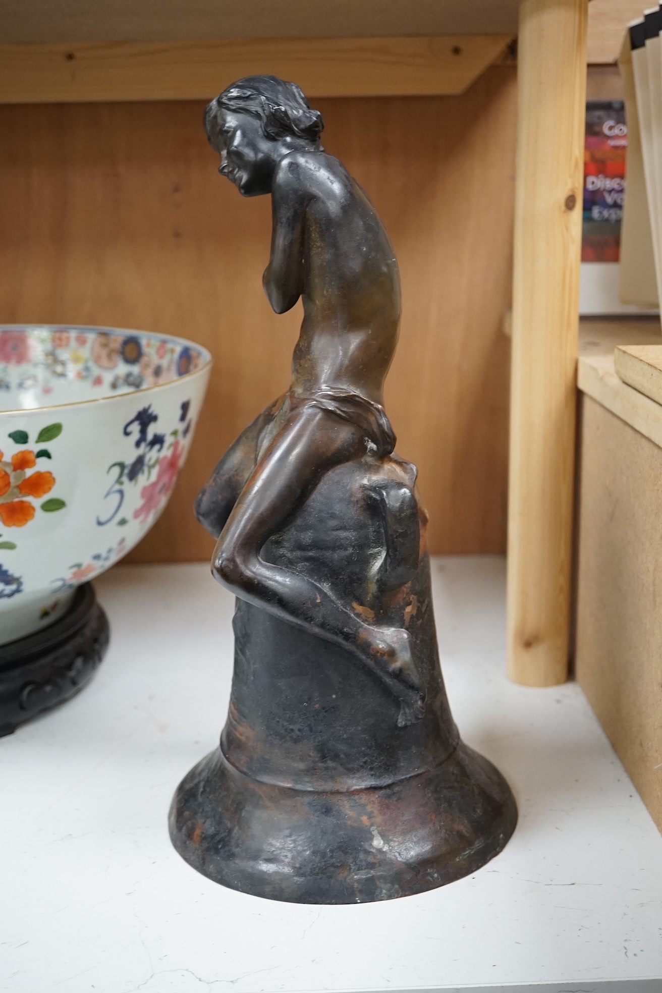 After Henri Pernot (1859-1937), a bronze figure of a boy seated on a bell, signed, 38cm high. Condition - fair to good